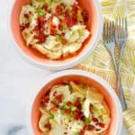 overhead view of two bowls of homemade Olive Garden tortellini al forno