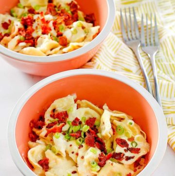 two bowls of homemade Olive Garden tortellini al forno and two forks