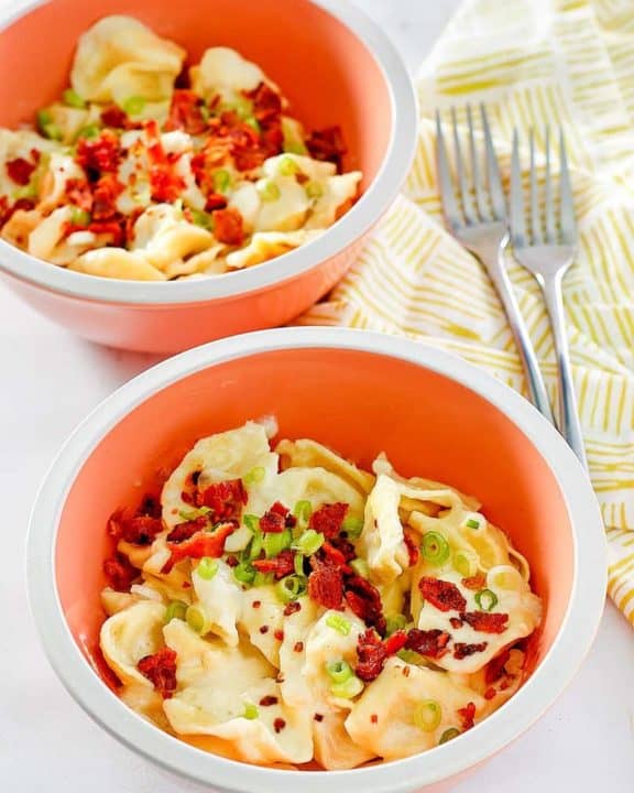 two bowls of homemade Olive Garden tortellini al forno and two forks