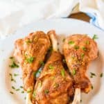 three roasted turkey legs and a kitchen towel