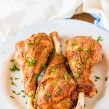 three roasted turkey legs and a kitchen towel