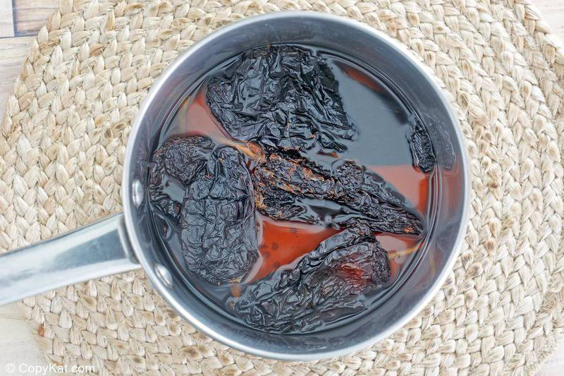 ancho chile peppers and water in a pan
