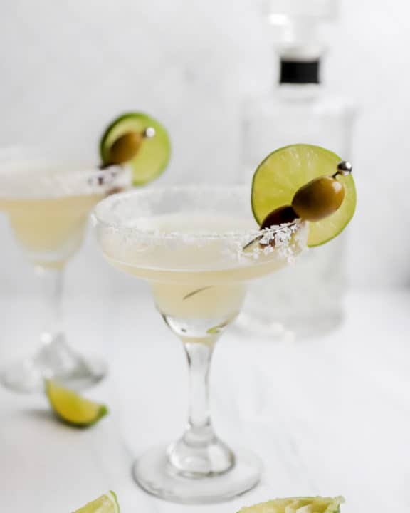 homemade Applebee's perfect margarita, fresh limes, and bottle of tequila