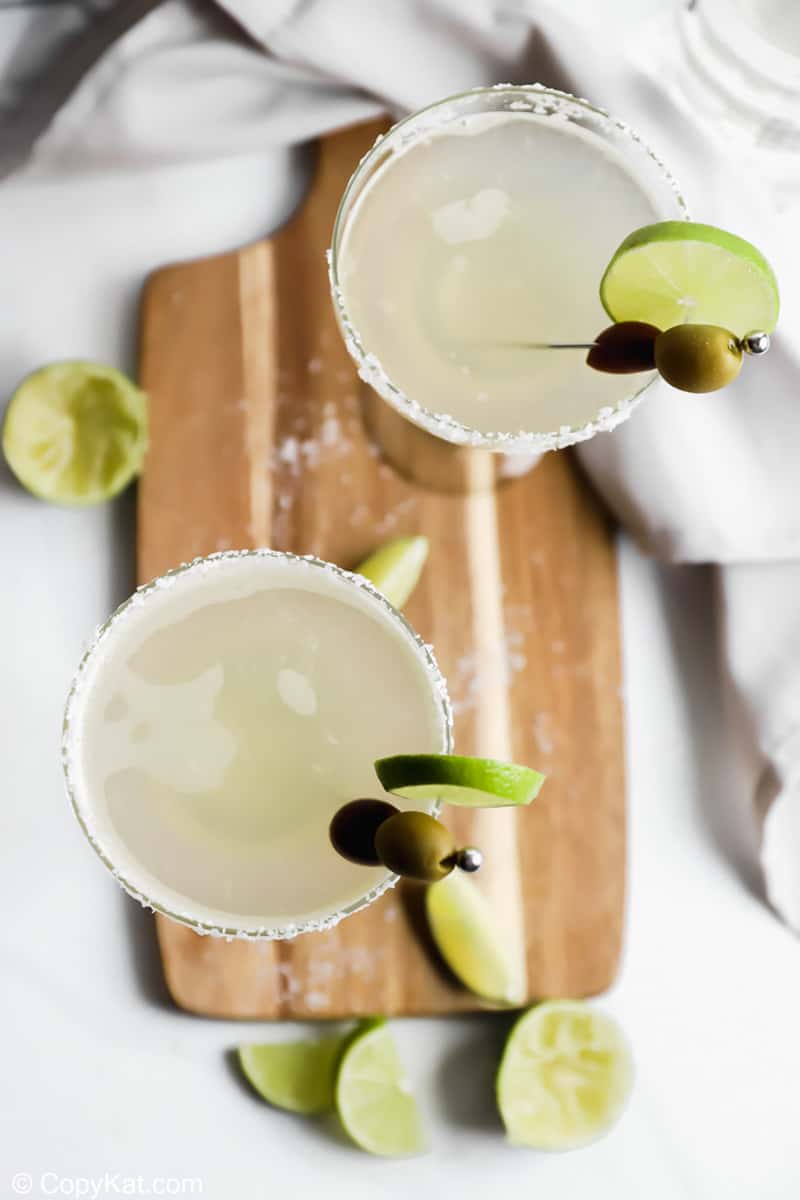 overhead view of homemade Applebee's perfect margaritas on a wood cutting board
