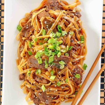 overhead view of beef chow fun on a platter