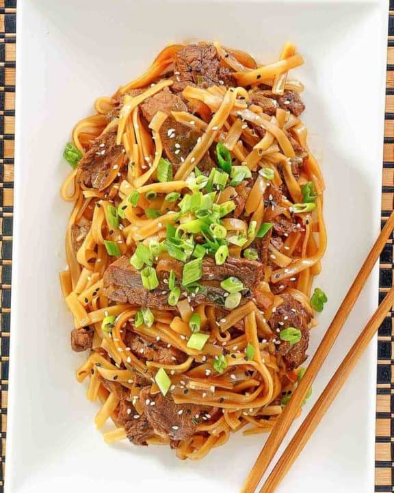 overhead view of beef chow fun on a platter