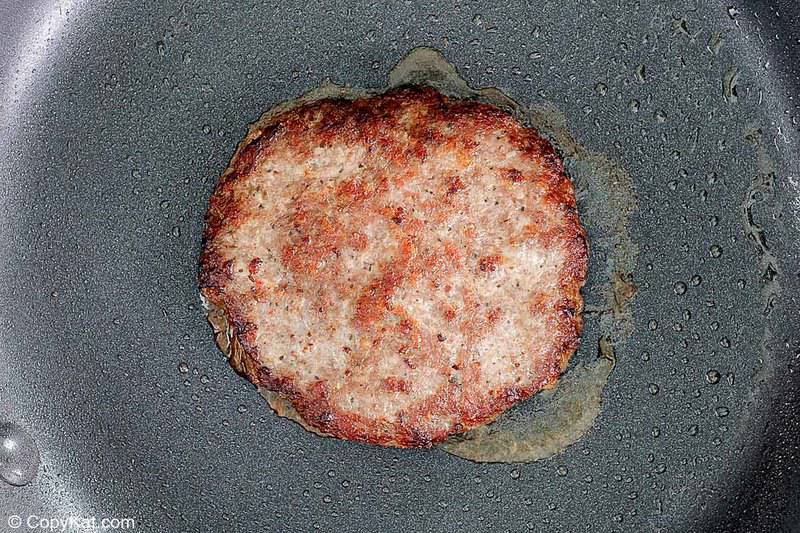 fried breakfast sausage patty in a skillet