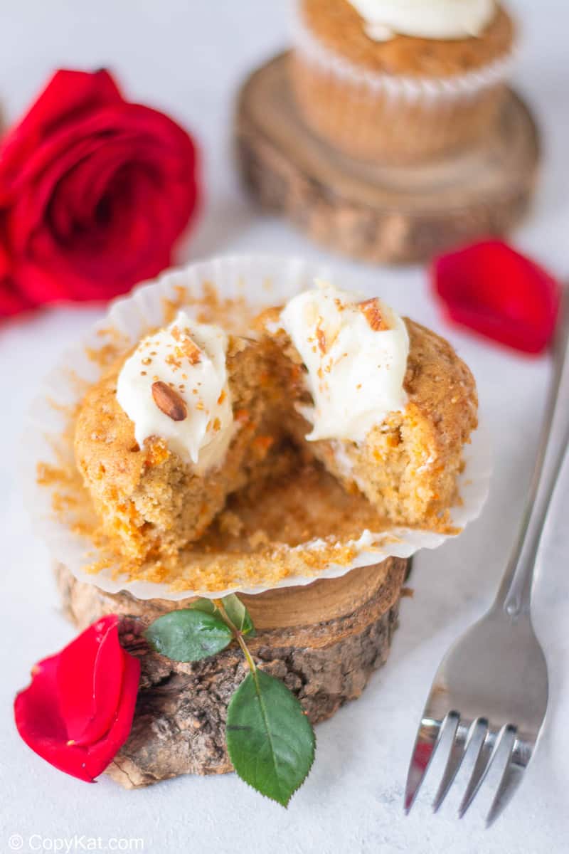 split open carrot cake cupcake with cream cheese frosting