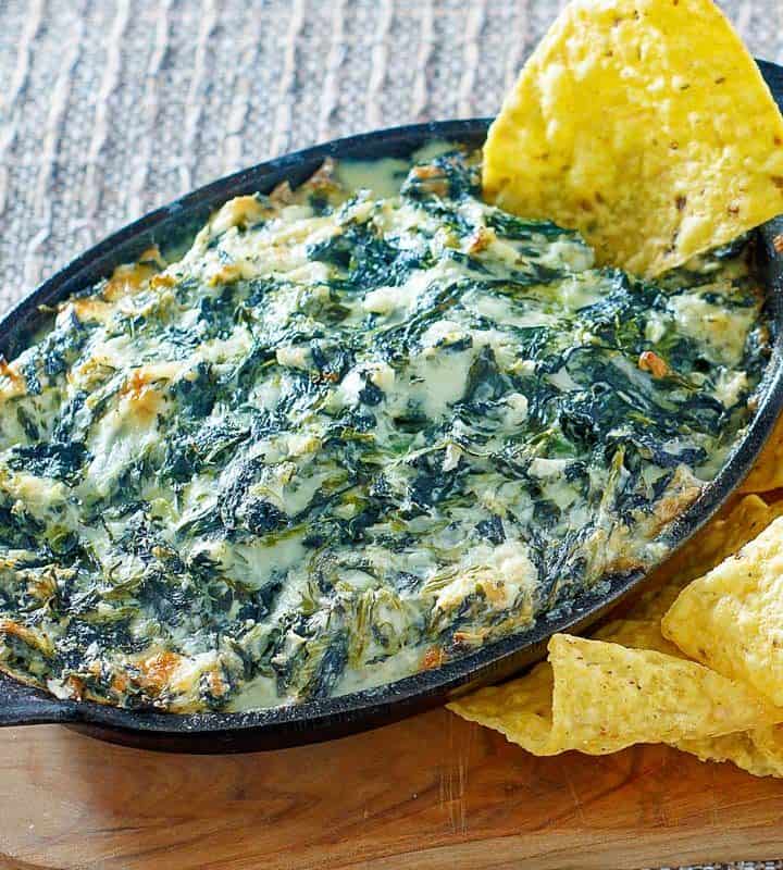 homemade Cheddars Santa Fe spinach dip and tortilla chips on a wood board