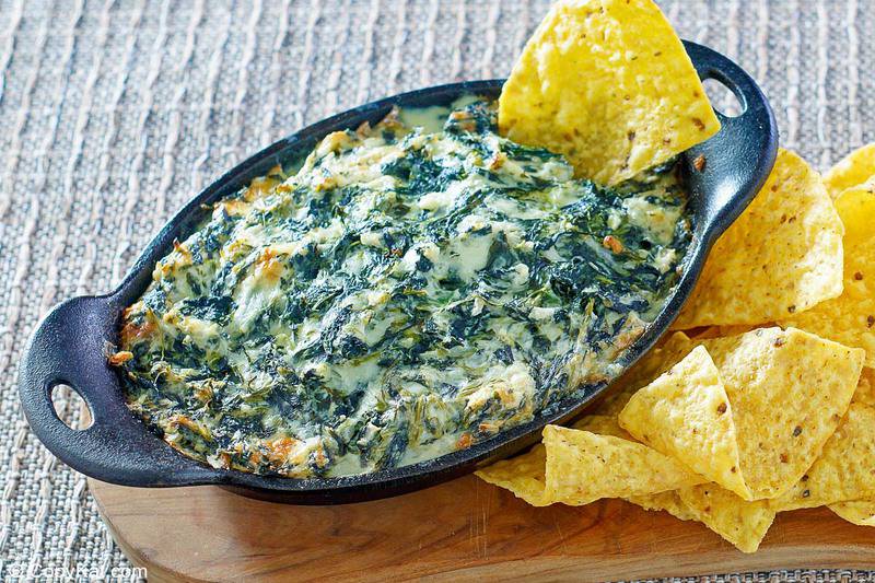 homemade Cheddars Santa Fe spinach dip and tortilla chips on a wood board