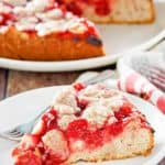 cherry coffee cake on a plate in front of the cake