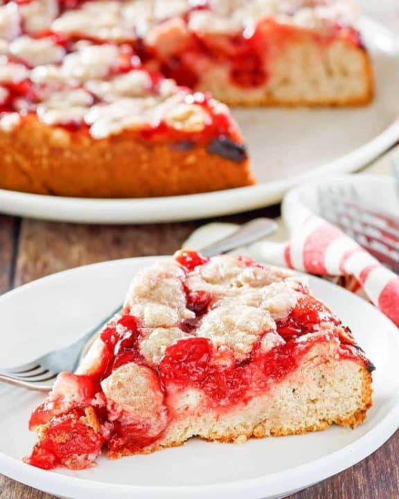 cherry coffee cake on a plate in front of the cake