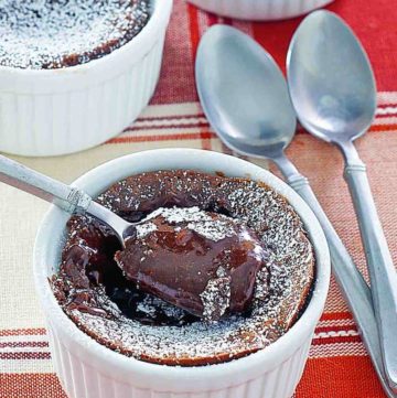 three chocolate melting cake desserts and spoons