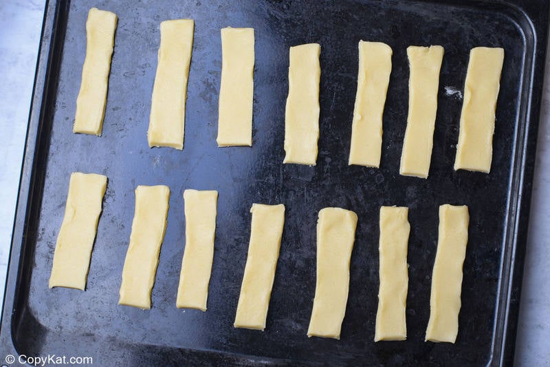 cookie dough strips for homemade Twix bars on a baking sheet