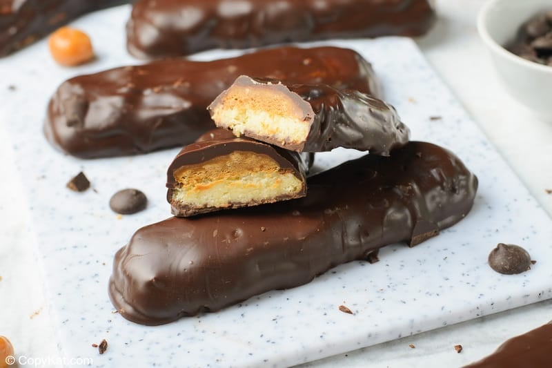 four homemade Twix bars on a cutting board