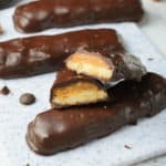 four homemade Twix bars on a cutting board