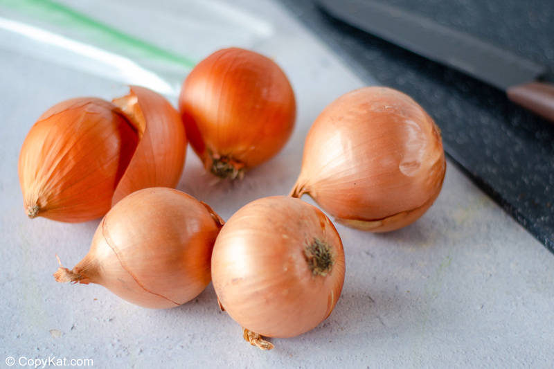 whole onions on a cutting board