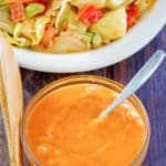 homemade French salad dressing in a bowl next to a salad