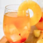 a glass of pineapple white wine sangria