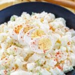 homemade potato salad topped with sliced egg in a bowl