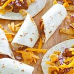 homemade Sonic Frito chili cheese wraps on a wood board