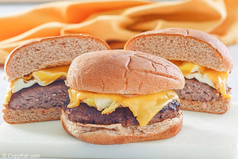 two homemade Whataburger Breakfast on a Bun sandwiches with sausage, egg, and cheese