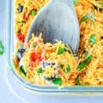 7 layer dip and a serving spoon in a dish