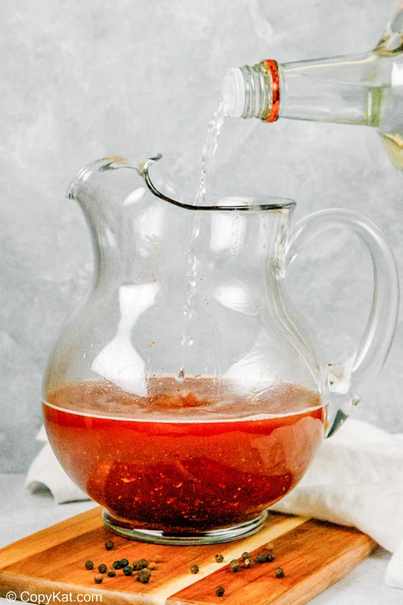 pouring vodka into homemade bloody mary mix