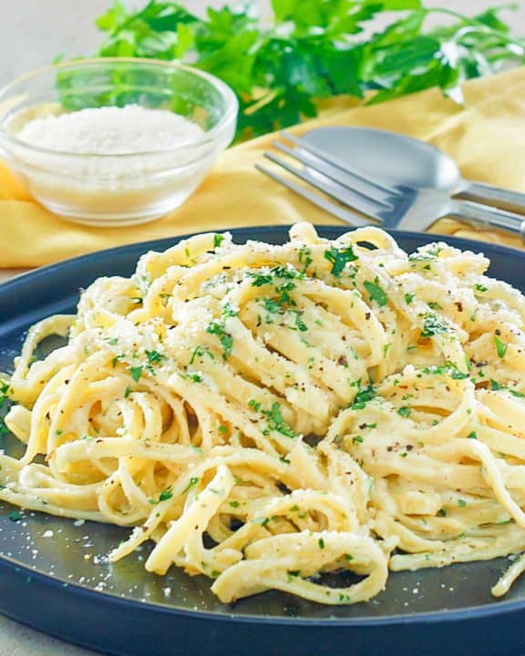 creamy alfredo sauce with fettuccine noodles on a plate