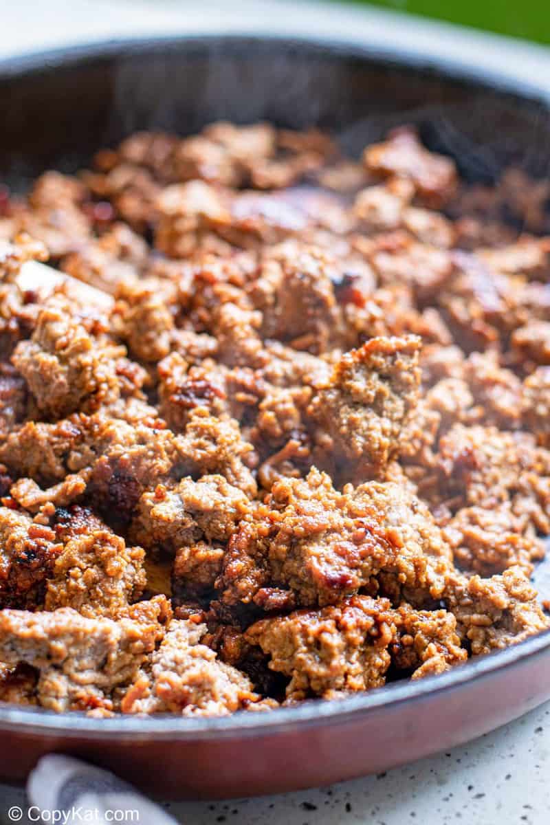 seasoned ground beef cooking in a skillet