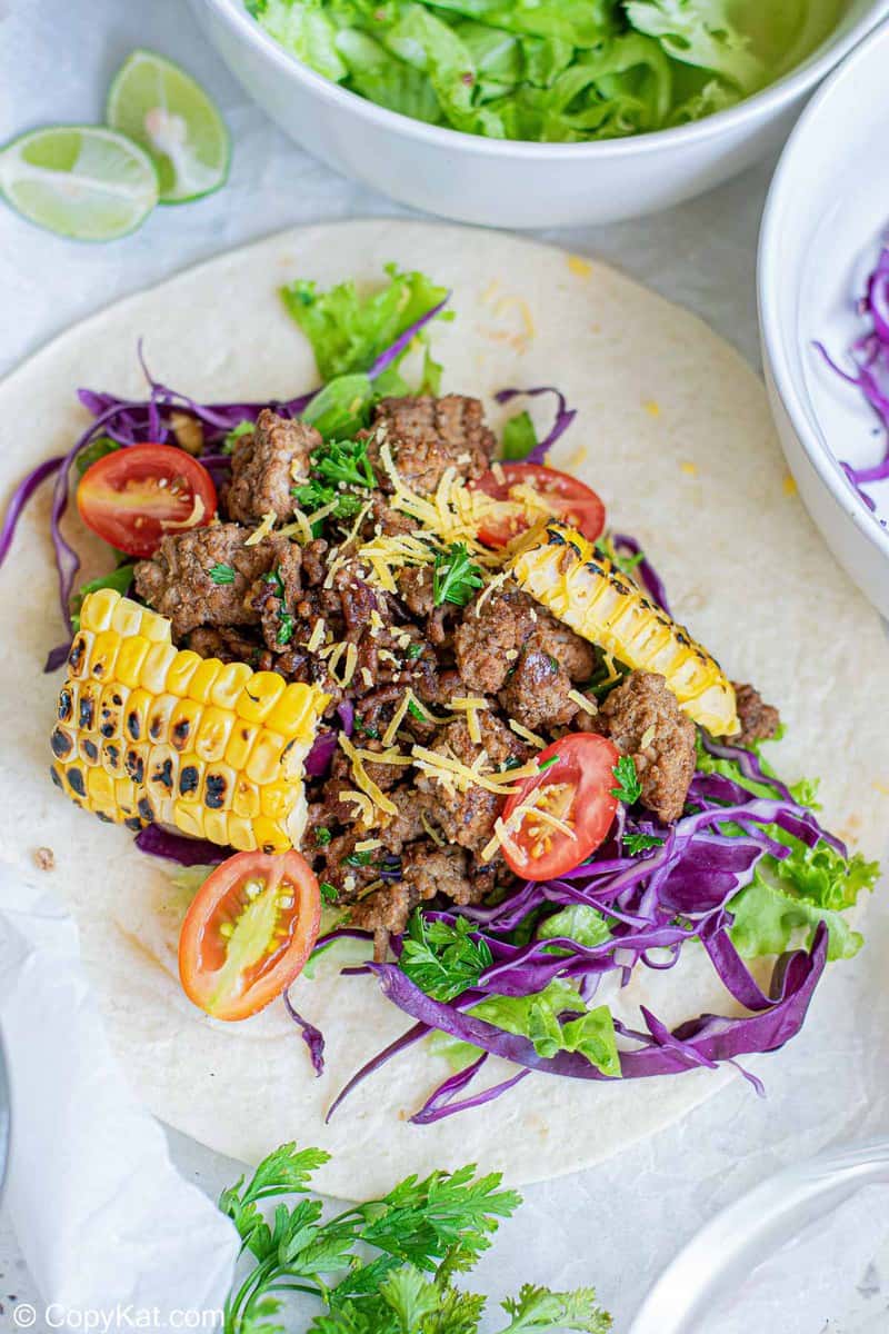 ground beef taco fillings on a flour tortilla