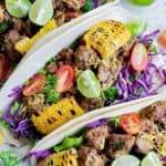 overhead view of ground beef tacos and a lime