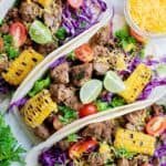 overhead view of three ground beef tacos with toppings