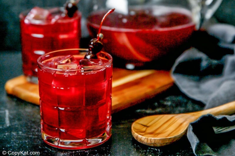 two glasses of homemade Joe's Crab Shack Ya Ya Punch and a wooden spoon