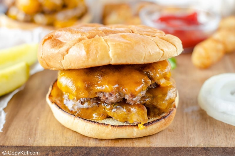 garlic double cheeseburger on a wood cutting board,