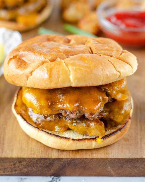 Homemade Steak and Shake garlic double cheeseburger on a wood cutting board.