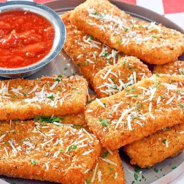 copycat TGI Friday's Fried Mozzarella Sticks and marinara sauce on a platter