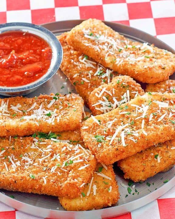 copycat TGI Friday's Fried Mozzarella Sticks and marinara sauce on a platter