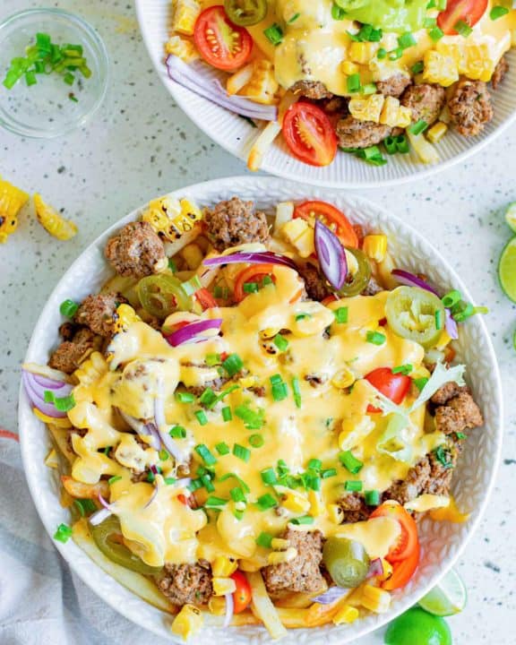 overhead view of two bowls of homemade Taco Bell Nacho Fries BellGrande