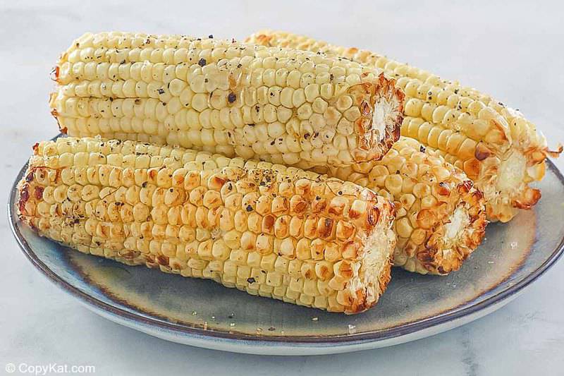 4 air fried corn on the cob pieces on a plate