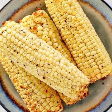 overhead view of air fried corn on the cob on a plate