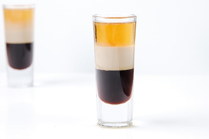 layers of Kahlua, Bailey's Irish Cream, and Grand Marnier in a shot glass