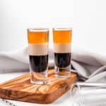 two B52 shots, a cocktail spoon, and shot glass
