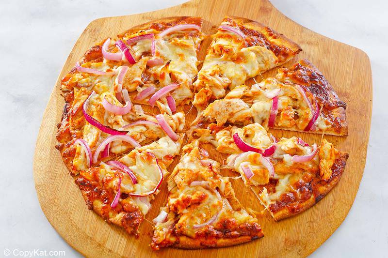 slices of homemade CPK barbecue chicken pizza on a pizza peel