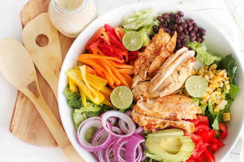 chicken fajita salad, creamy salsa verde dressing, and wood salad servers