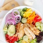 overhead view of chicken fajita salad and creamy salsa verde dressing