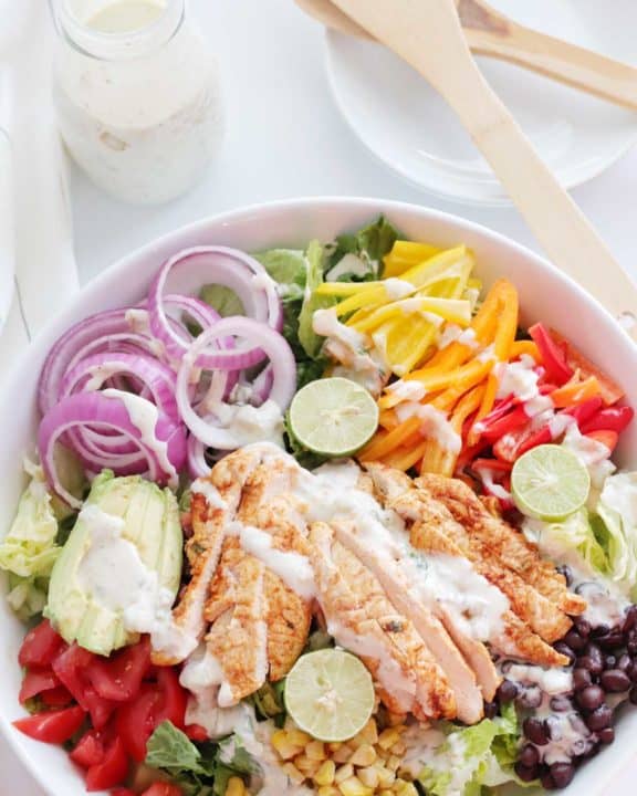 overhead view of chicken fajita salad with creamy salsa verde dressing