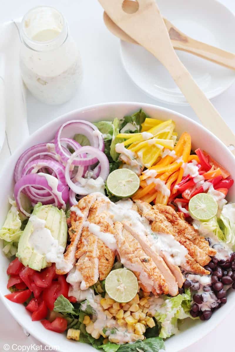 overhead view of chicken fajita salad with creamy salsa verde dressing