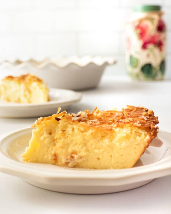 a slice of coconut custard pie on a plate