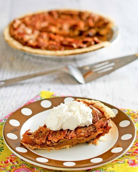 a slice of chocolate pecan pie on a plate